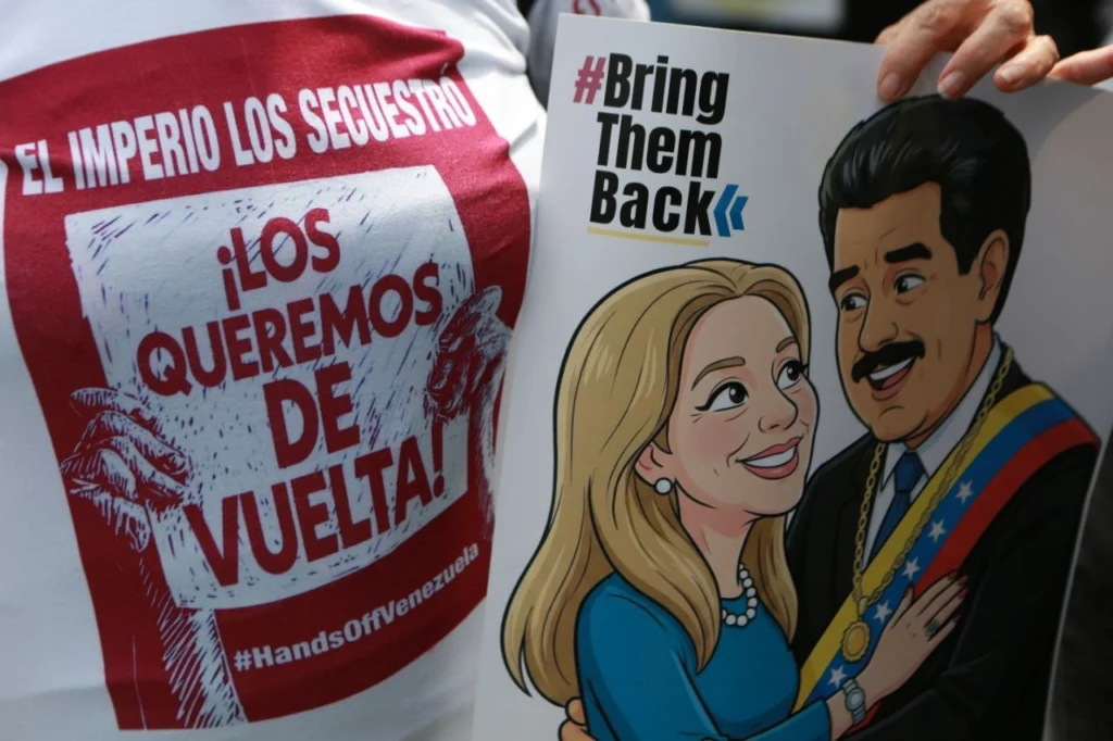 A protester in Caracas holds a poster of the Venezuelan presidential couple, with the slogan #BringThemBack, demanding their release from US imprisonment. Photo: Telesur.